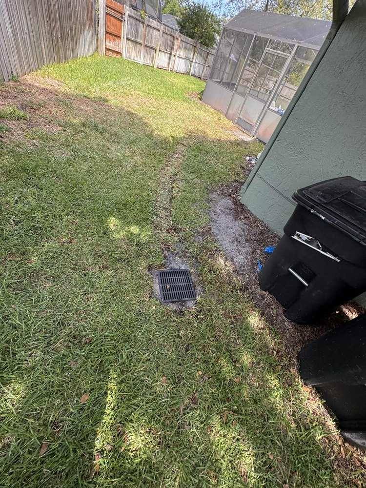 Small square drain grate set into a finished lawn